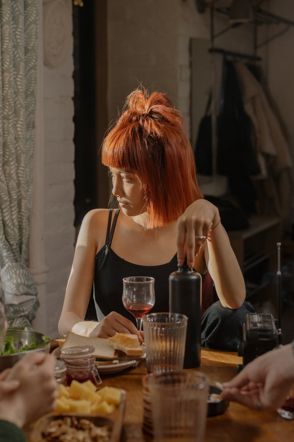 Woman in Black Tank Top Sitting at the Table