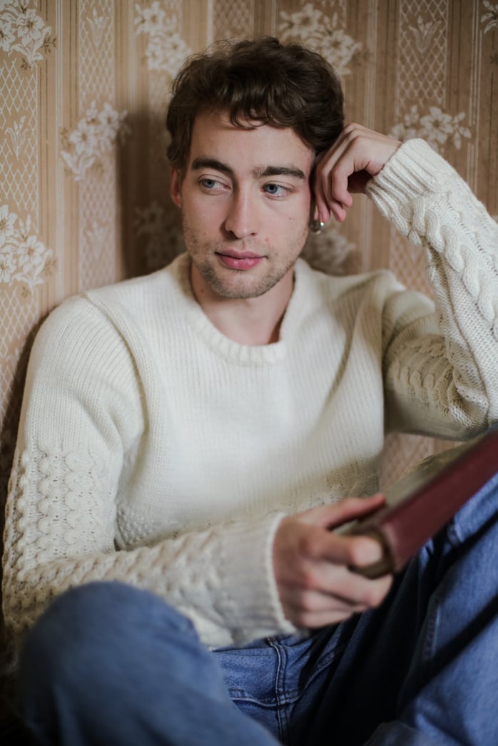 Woman in White Sweater Sitting on Brown Wicker Chair